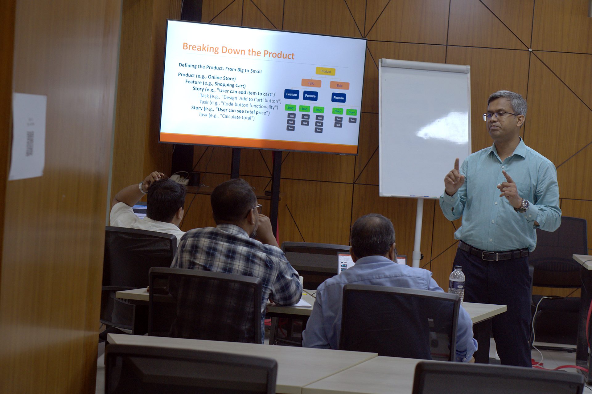 Trainer presenting Breaking Down the Product: product, feature, story and task