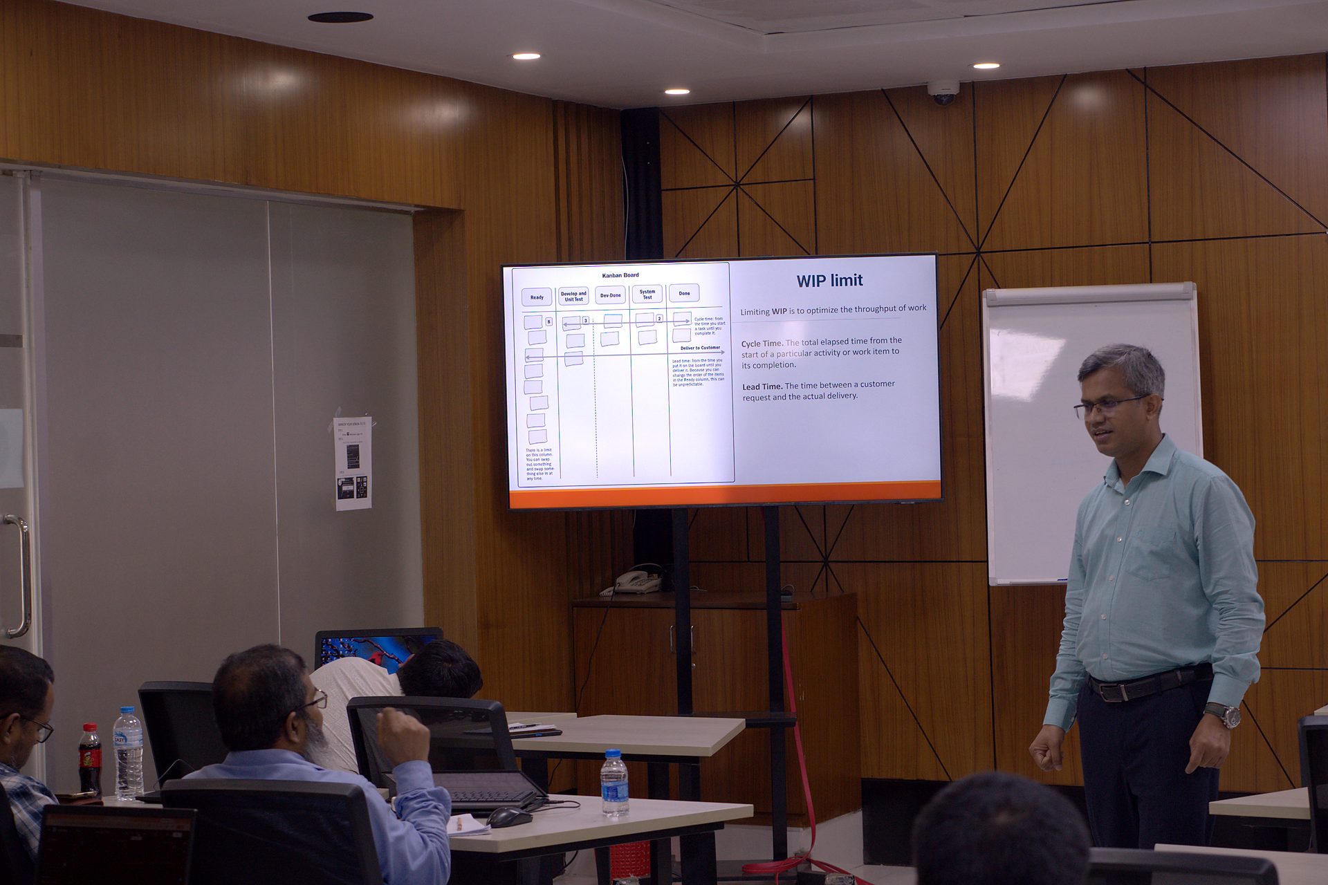 Kanban board and WIP limit slide on screen with the trainer