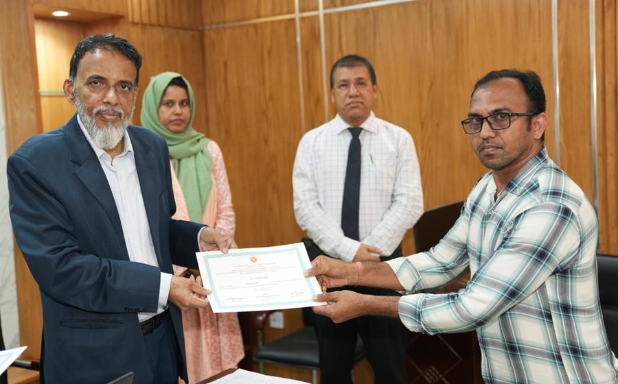 A participant receiving a certificate from the Secretary