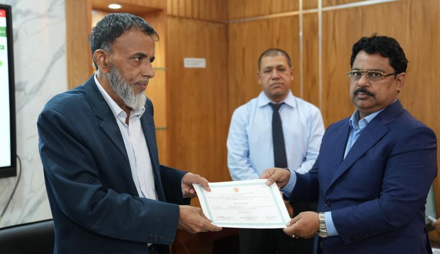A participant receiving a certificate from the Secretary