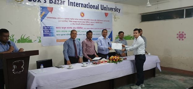 A participant receiving her certificate of completion