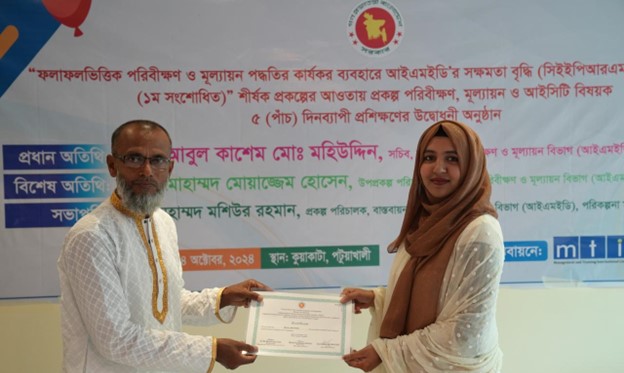 A participant receiving his certificate of completion from the Project Director