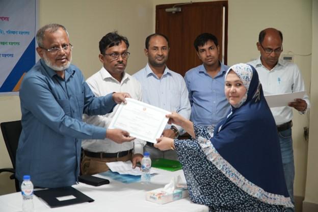 A participant receiving her certificate of completion from the Honorable Secretary