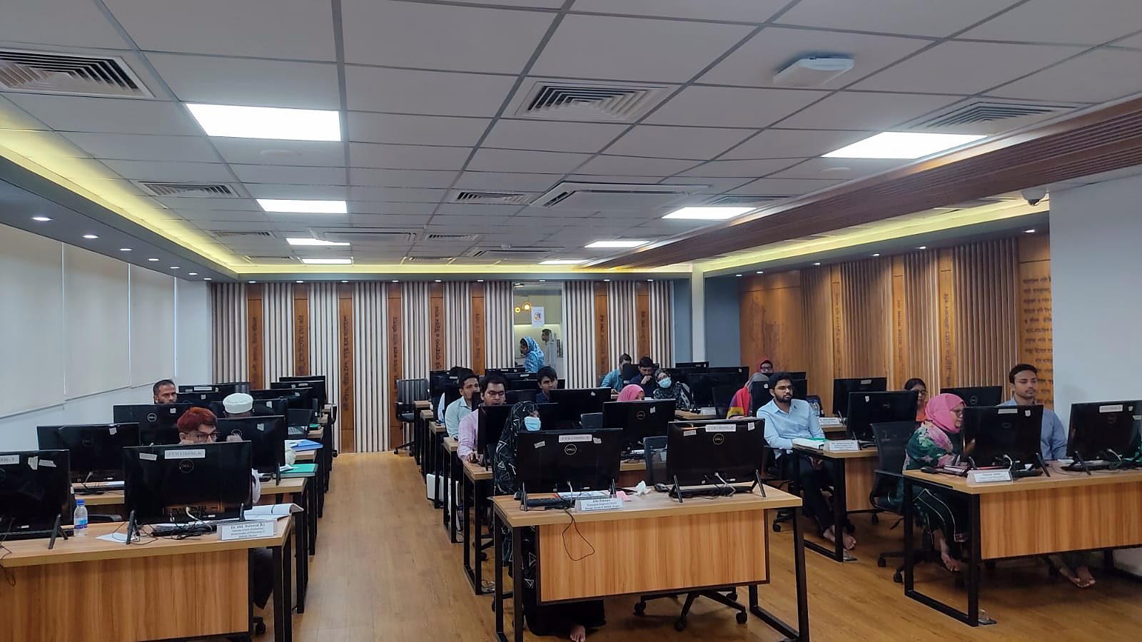 Participants at their workstations during the final day of the course