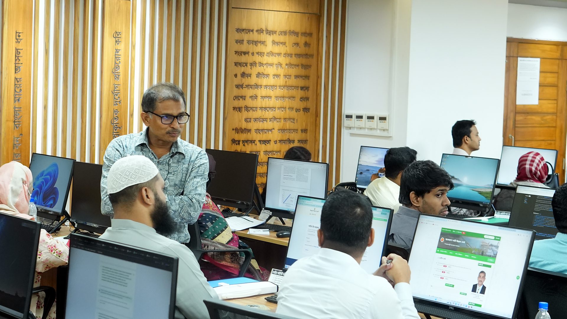 Resource person conducting a session among participants at their workstations in the Central ICT Lab
