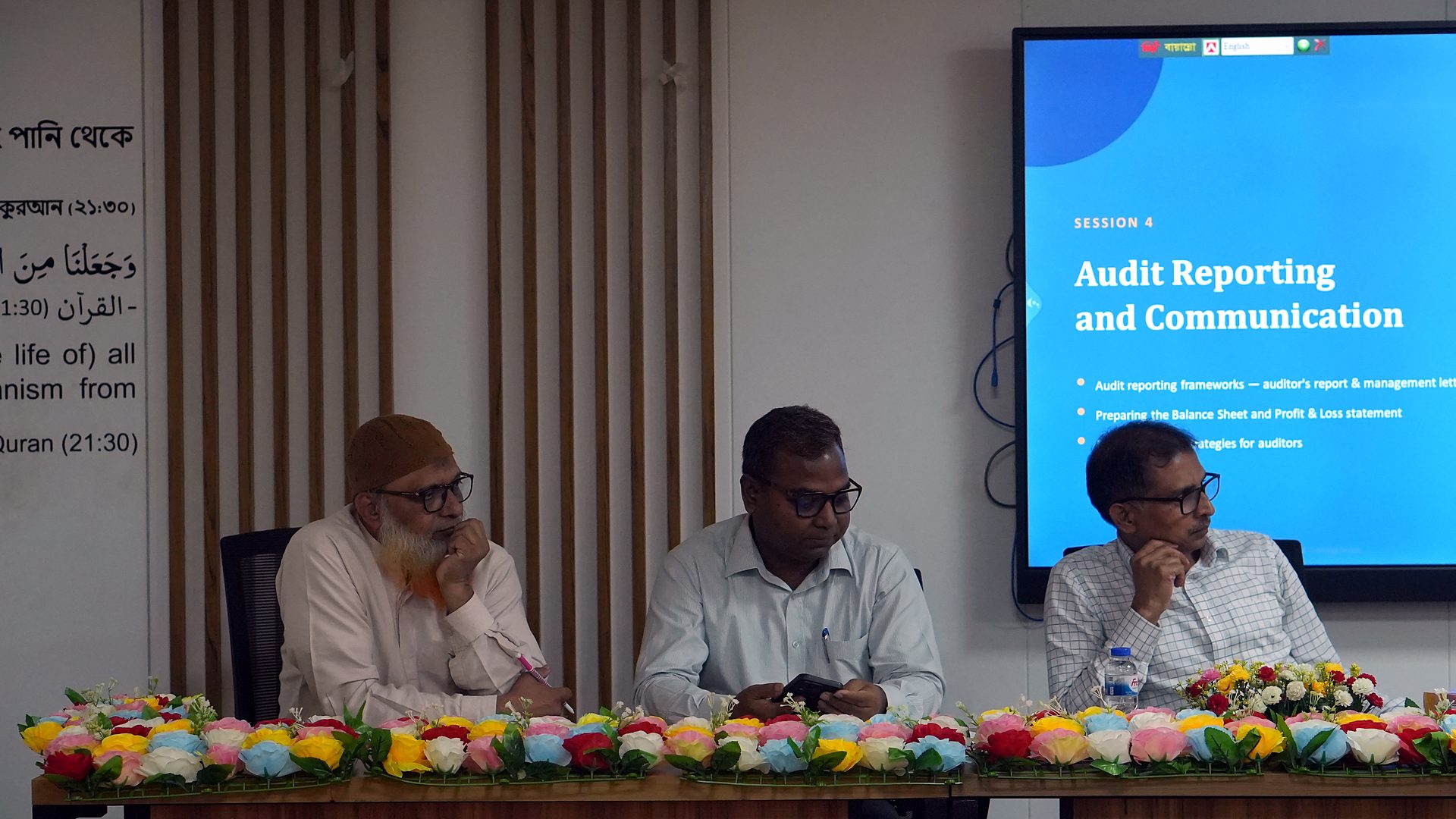 Resource persons at the dais with the Audit Reporting and Communication slide