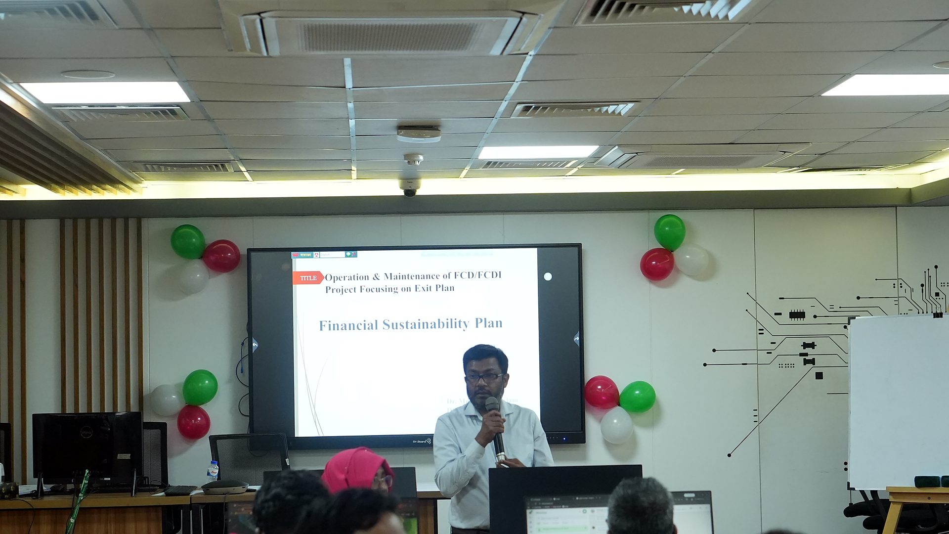 Financial Sustainability Plan slide on the screen