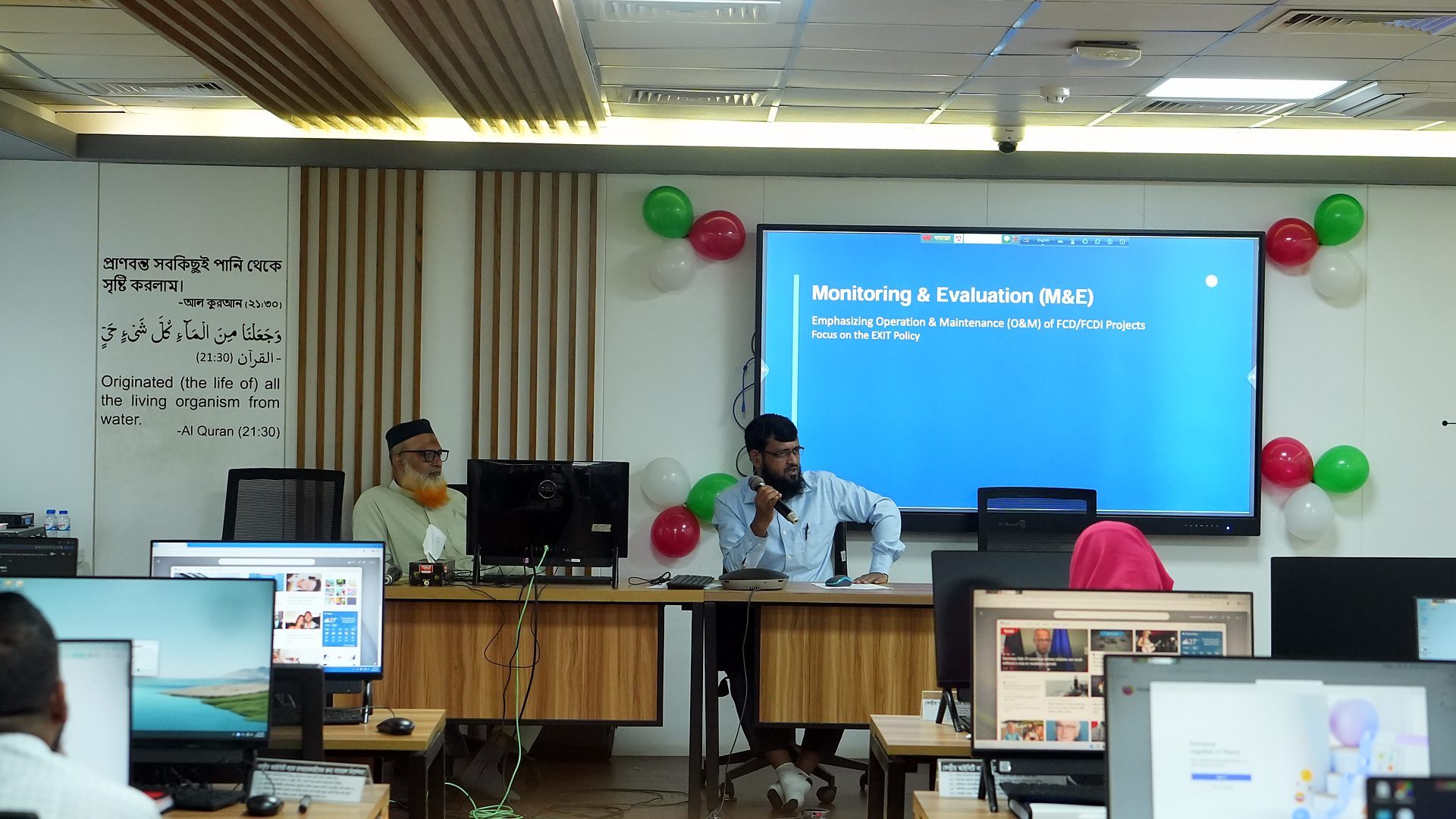 Monitoring and Evaluation slide with resource persons at the dais
