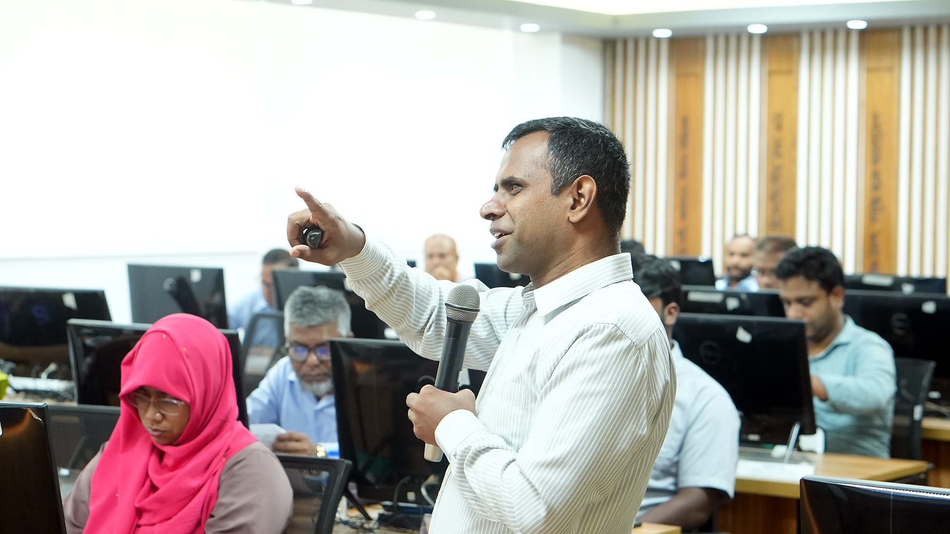 A participant asking a question with a microphone