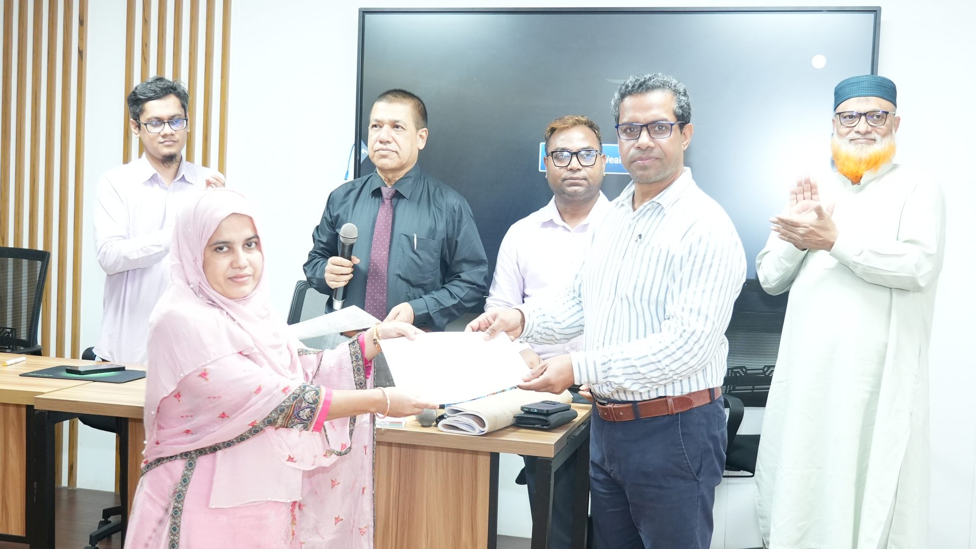 Participant receiving their course certificate