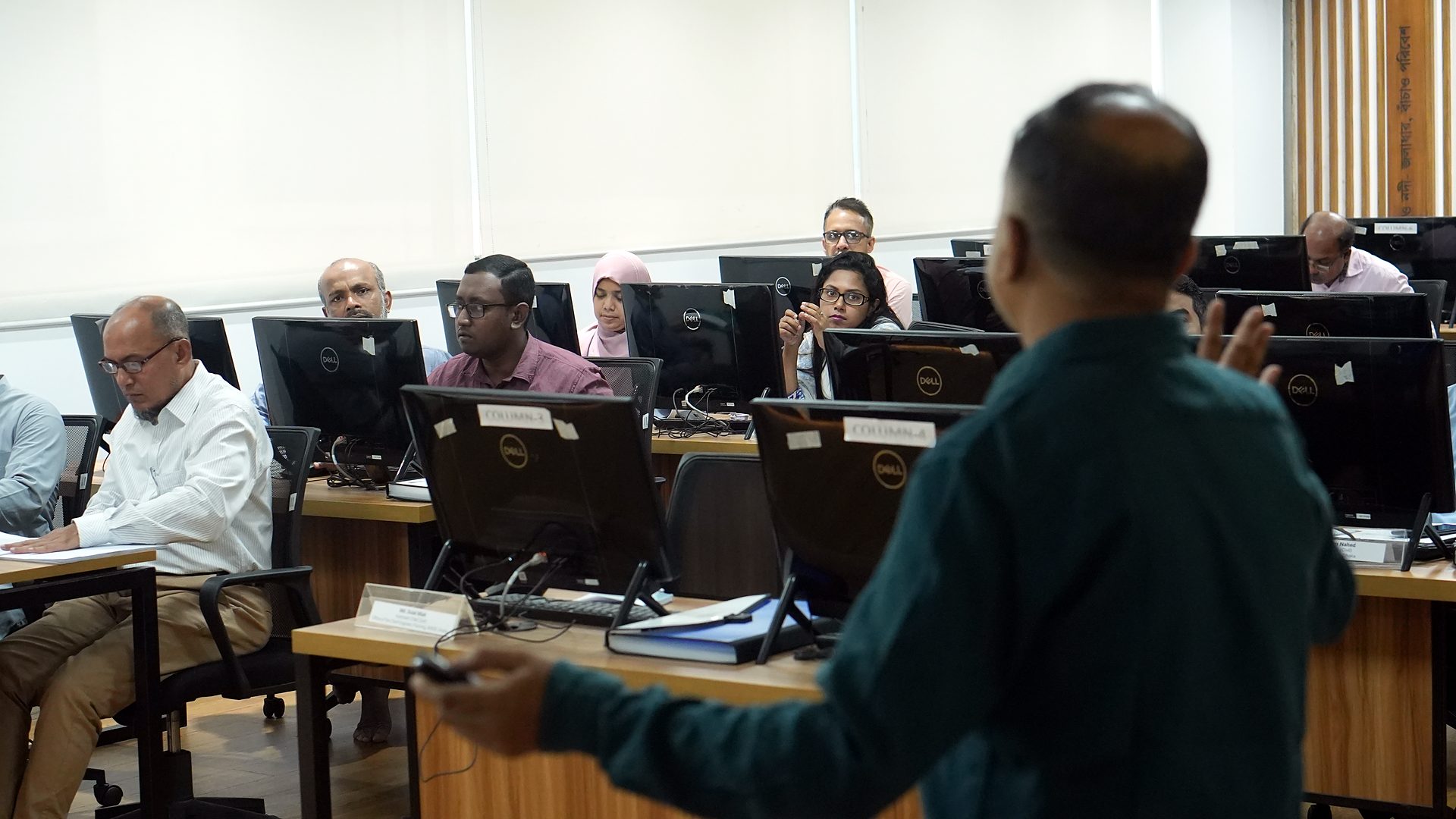 Resource person addressing participants at their workstations