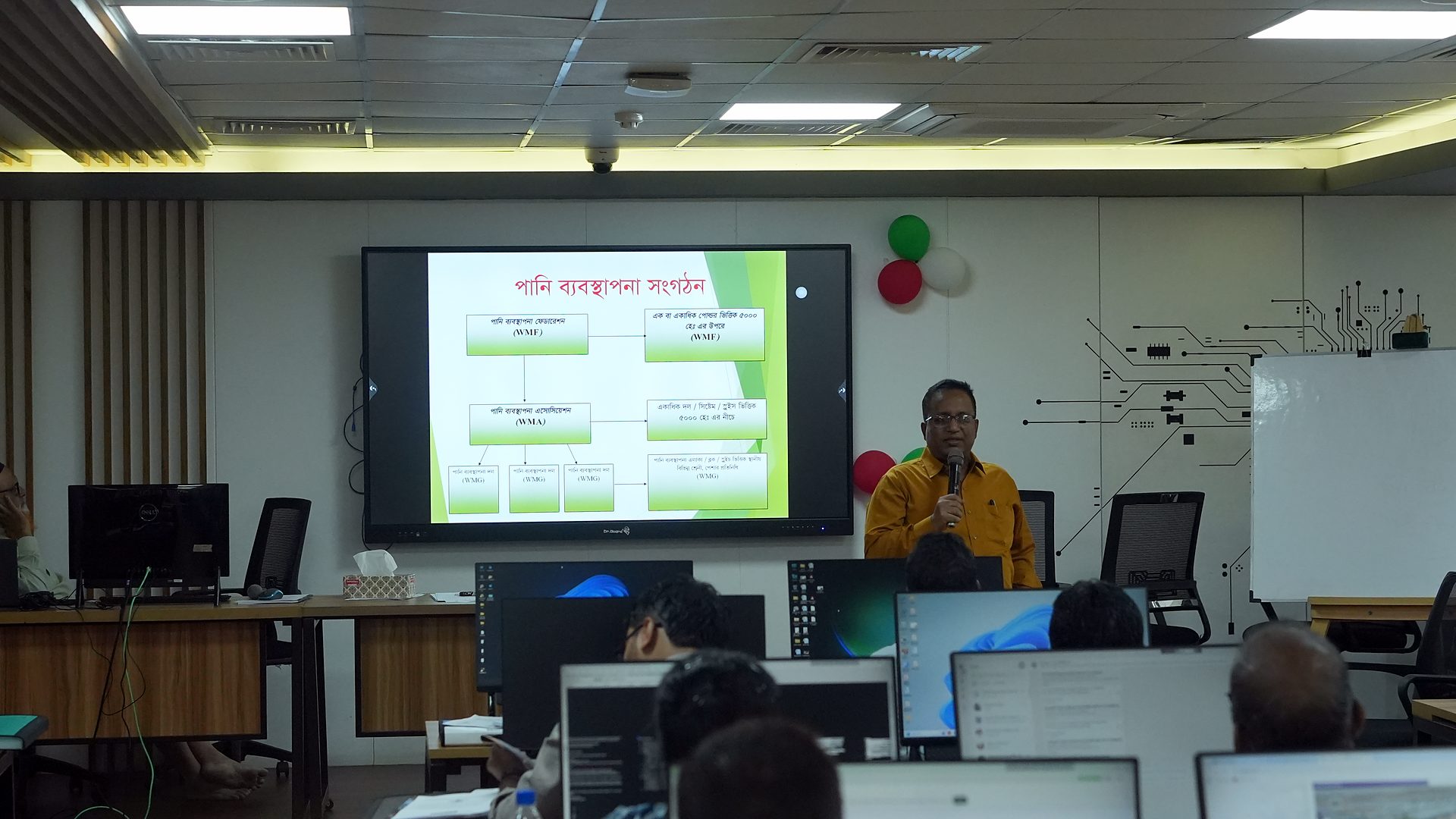 Resource person presenting a slide on the lab screen