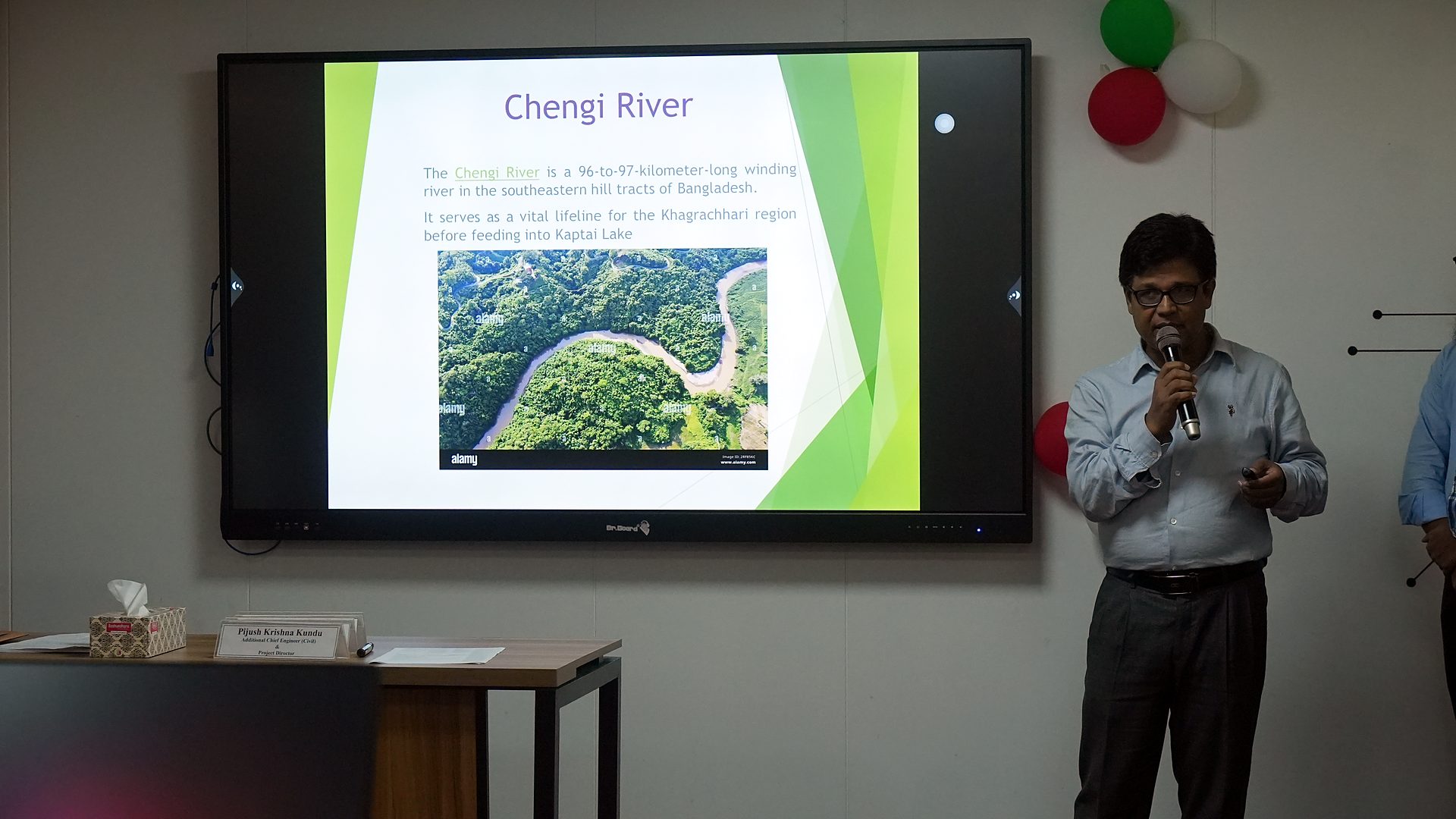 Presenter beside a Chengi River slide