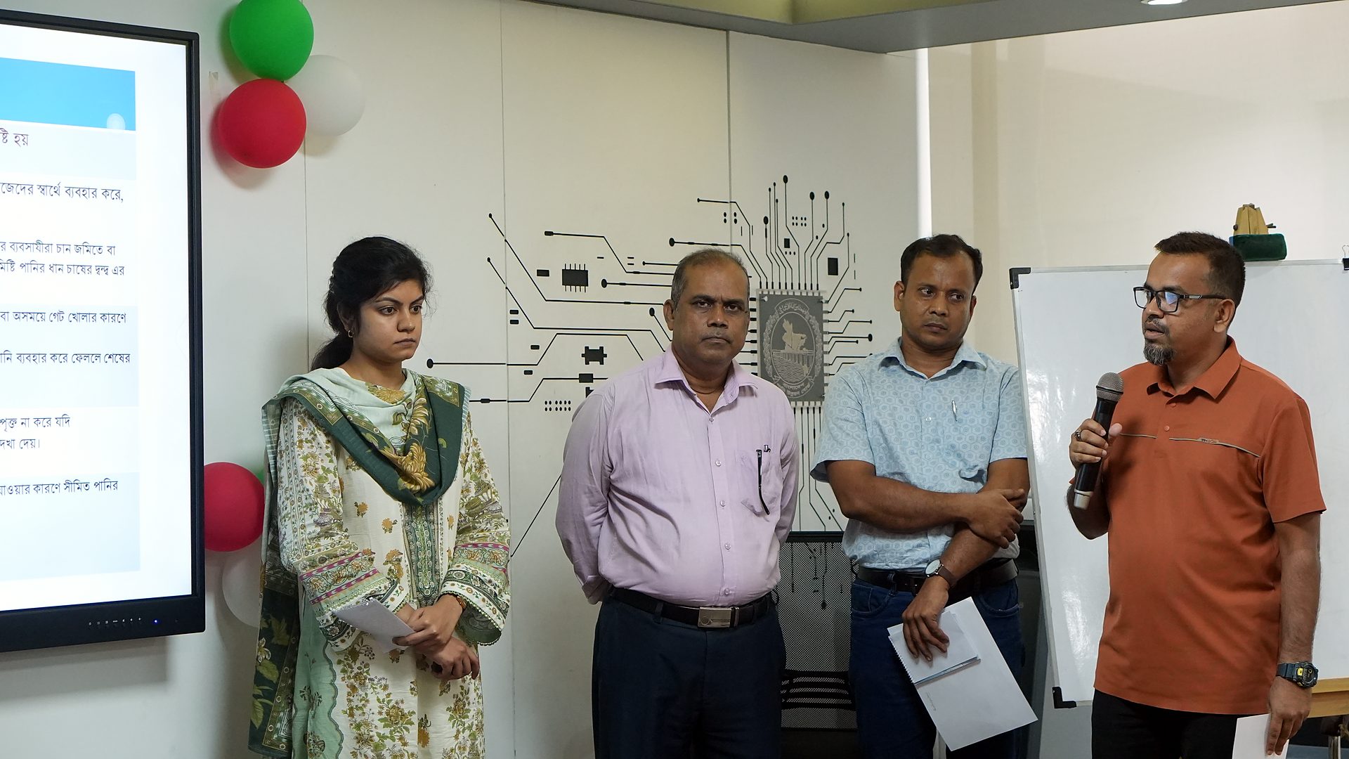 Group presenting with a slide on the lab screen