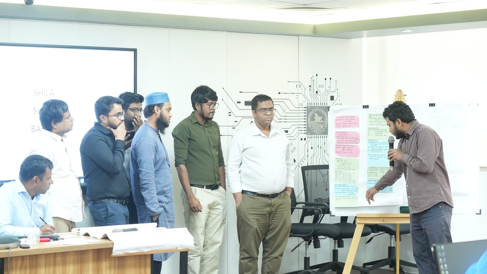 Participants presenting a poster on catchment assessment