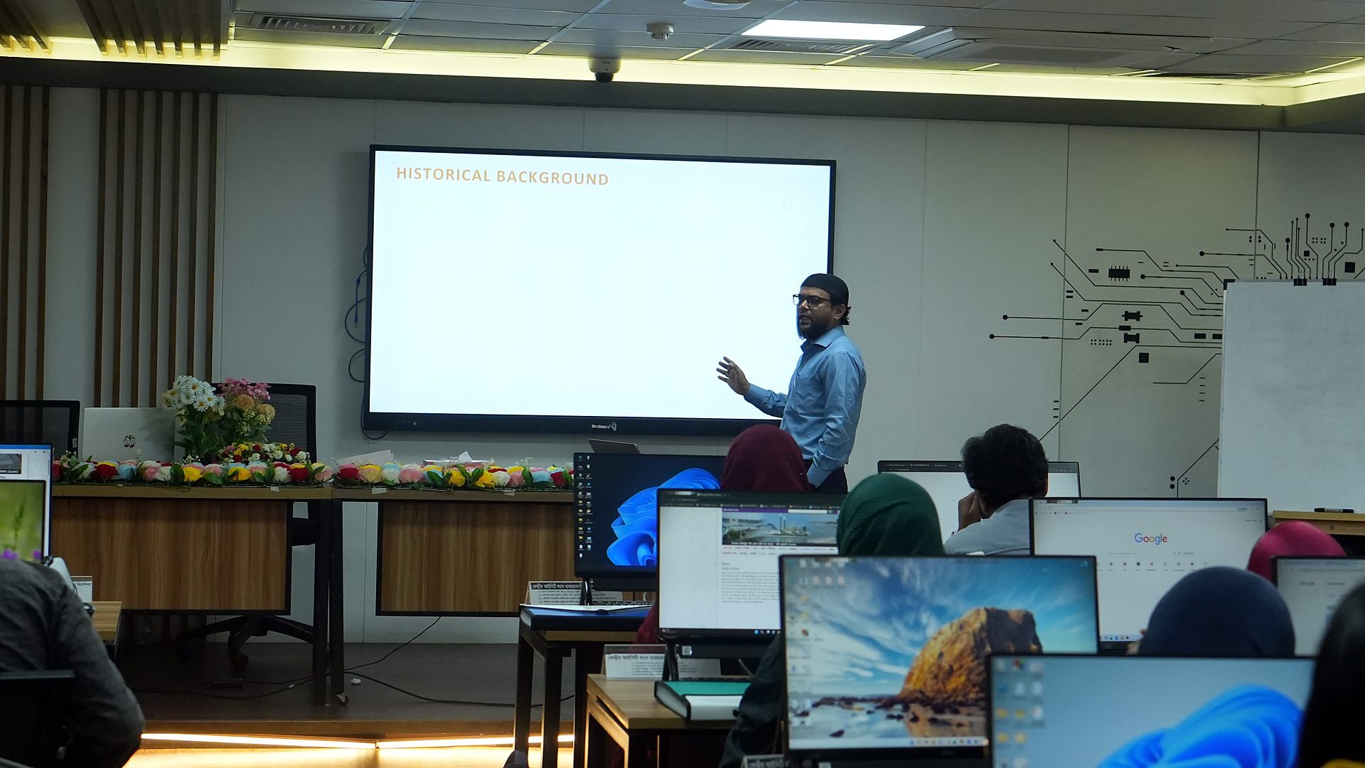 Resource person presenting in front of the lab screen