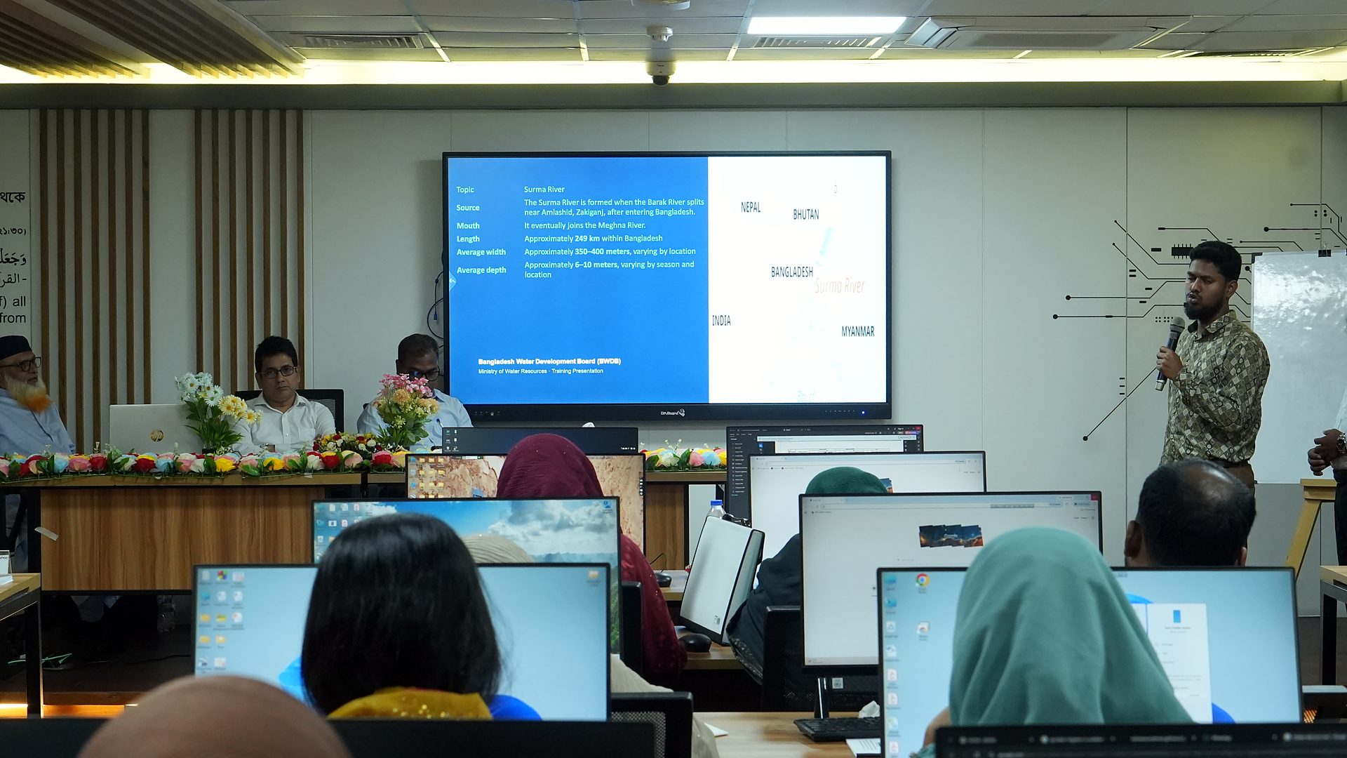 Team presenting a slide during the course review