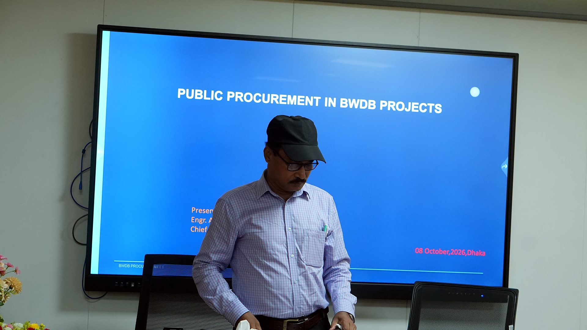 Resource person in front of the Public Procurement in BWDB Projects title slide