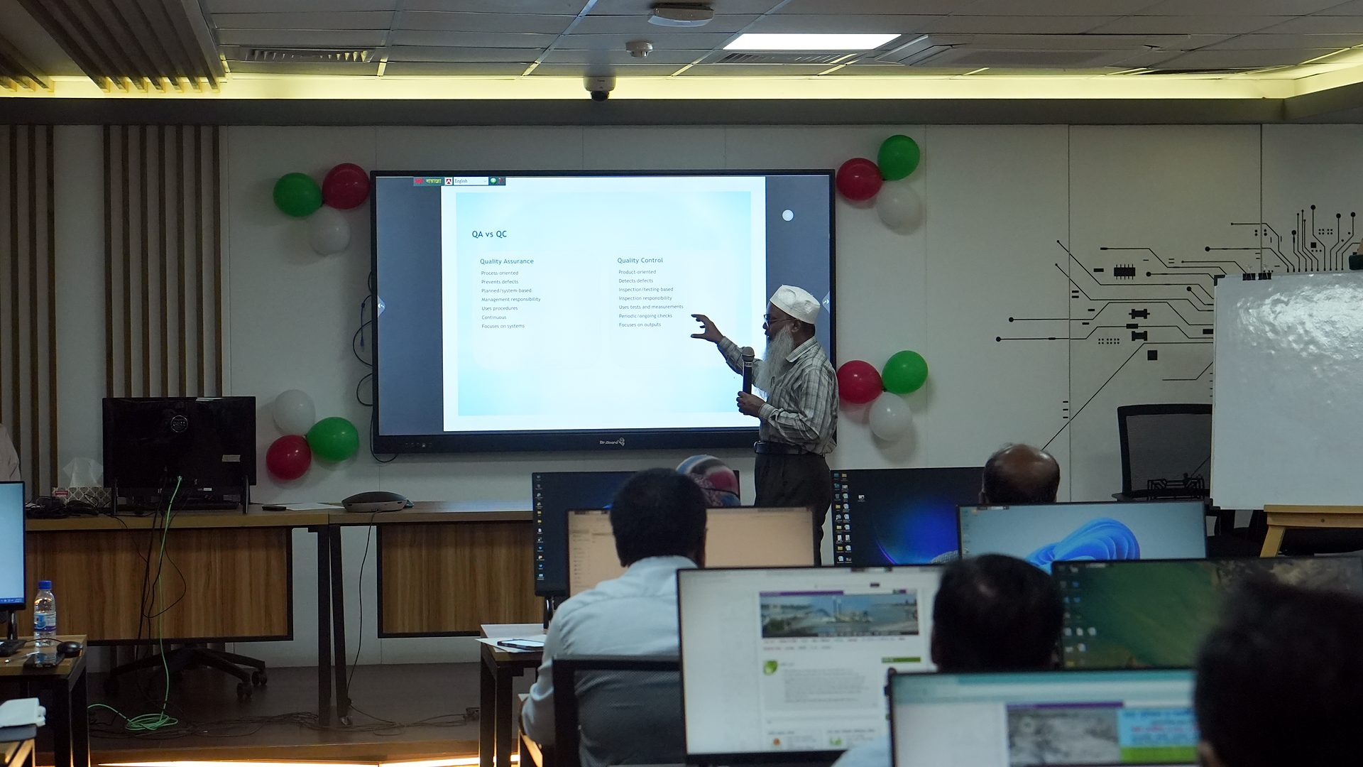 Resource person pointing to a slide