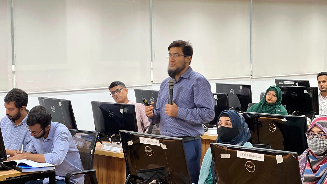 Participant standing to speak among the workstations