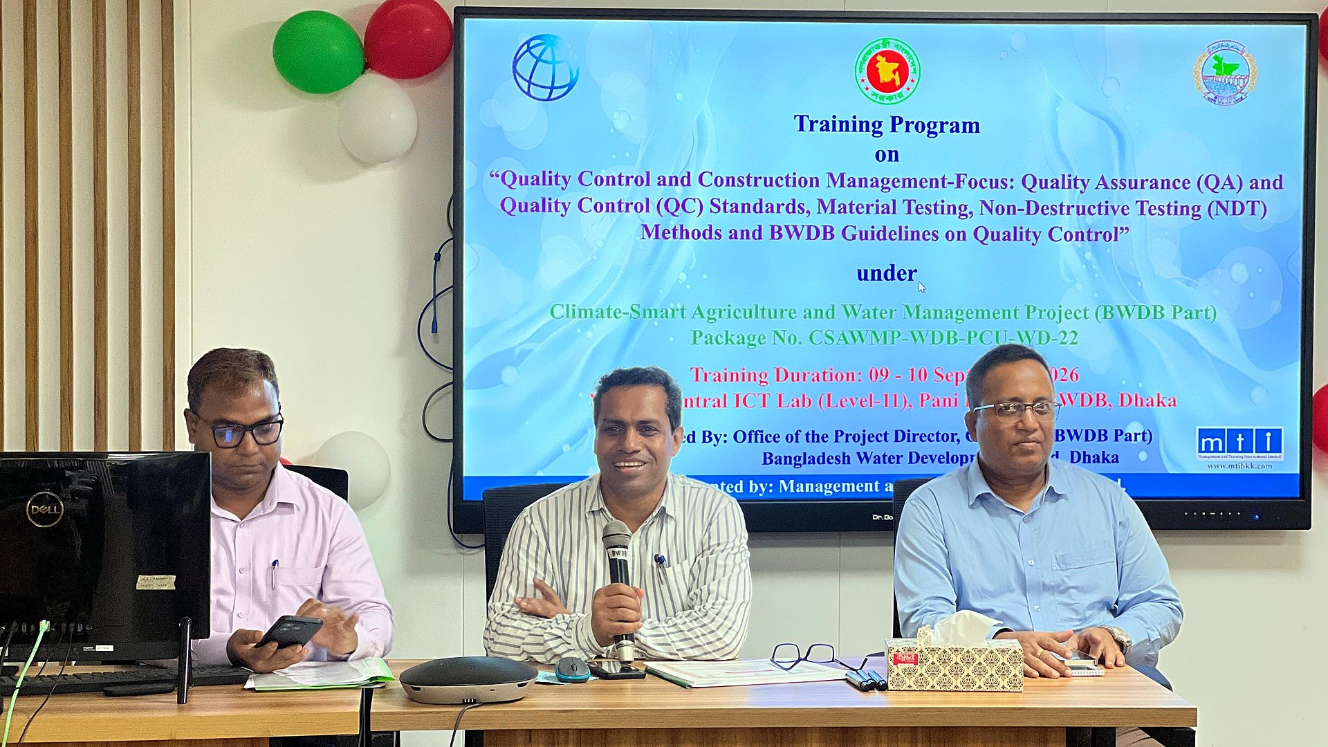 Officials at the dais under the course banner