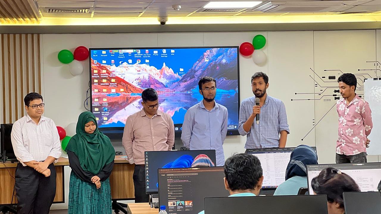 A participant group presenting at the front of the Central ICT Lab