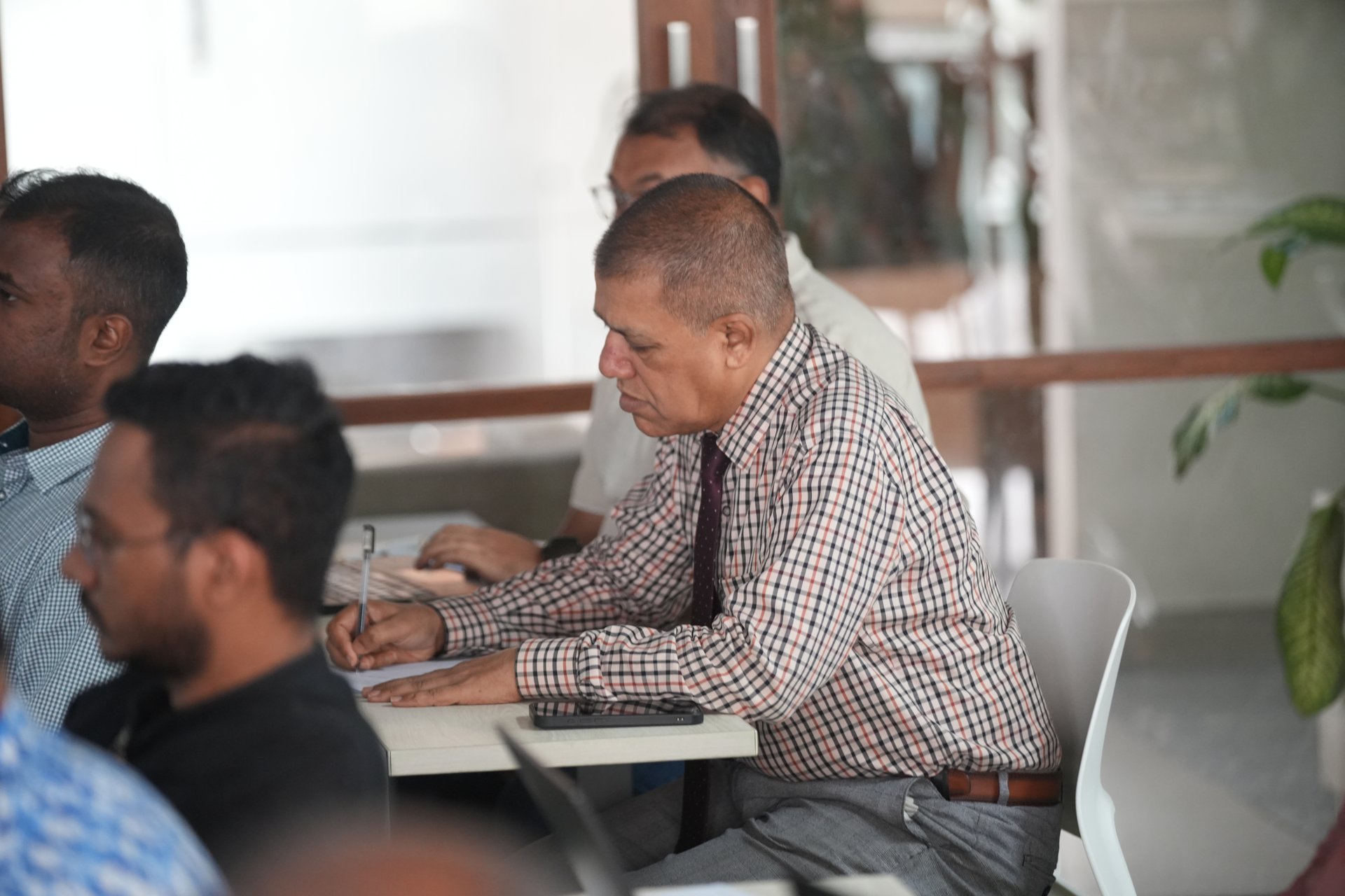 Dr. Md. Manirul Islam Khan taking notes during the session