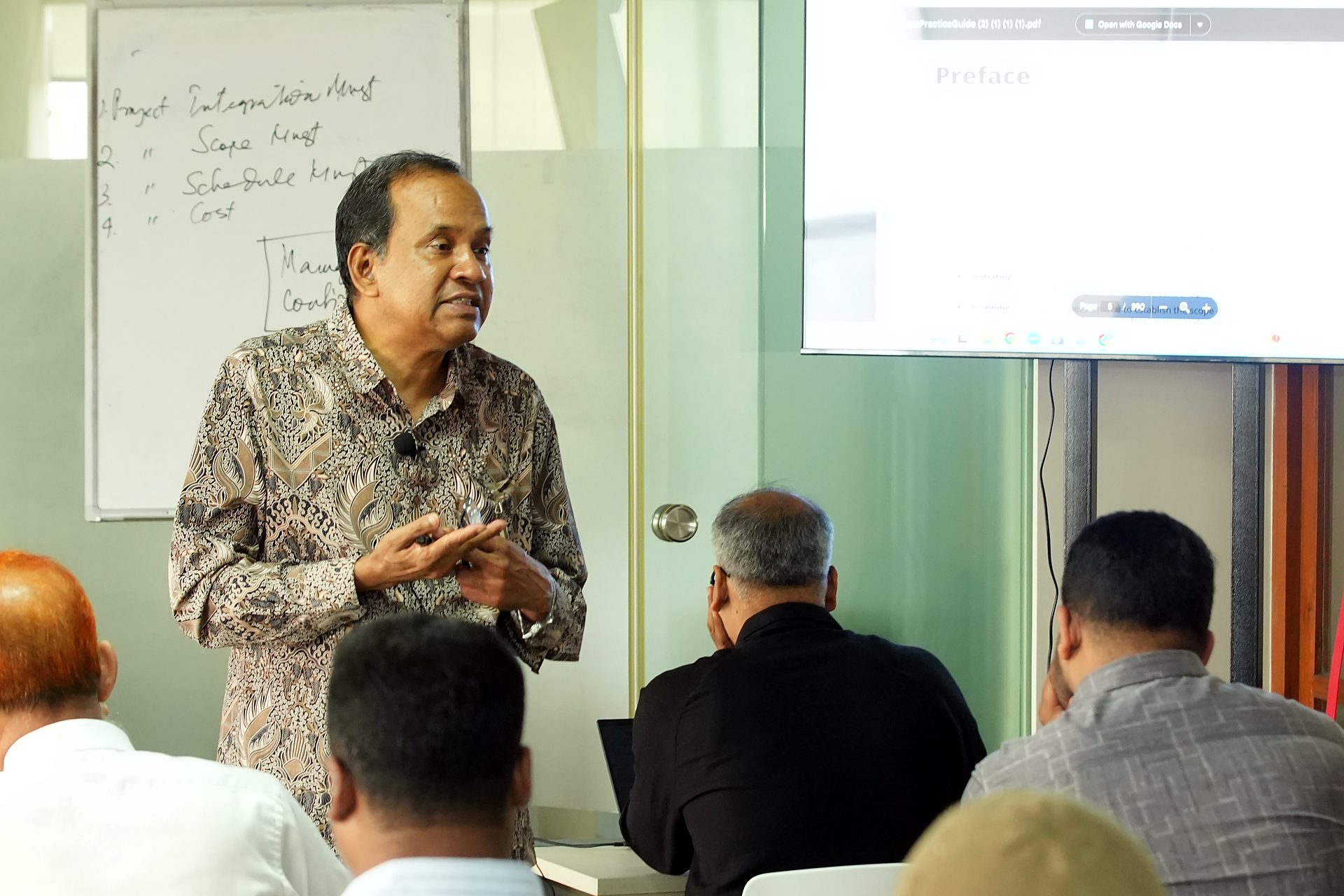 Trainer beside the knowledge-areas flipchart