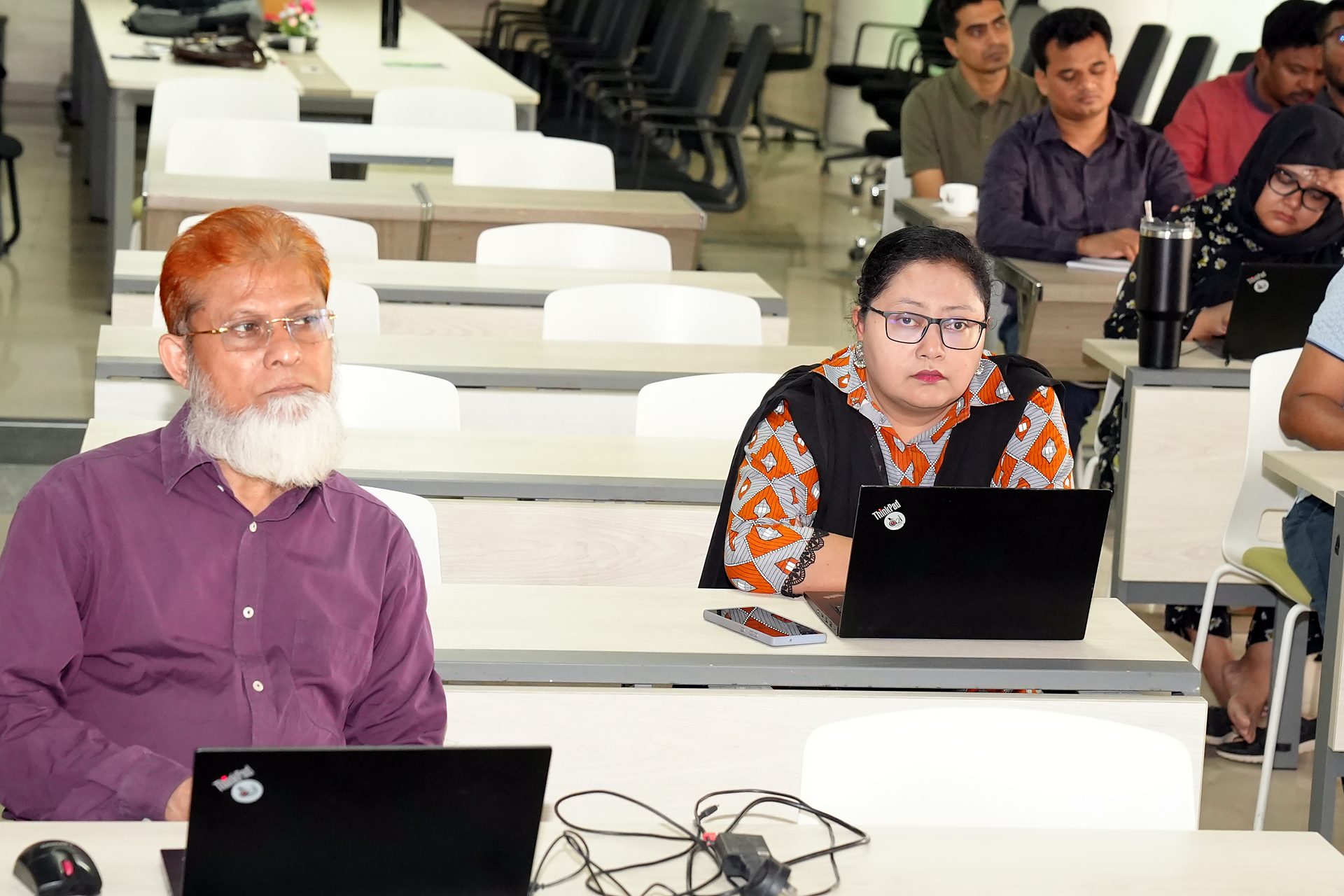 Participants at their laptops during the session