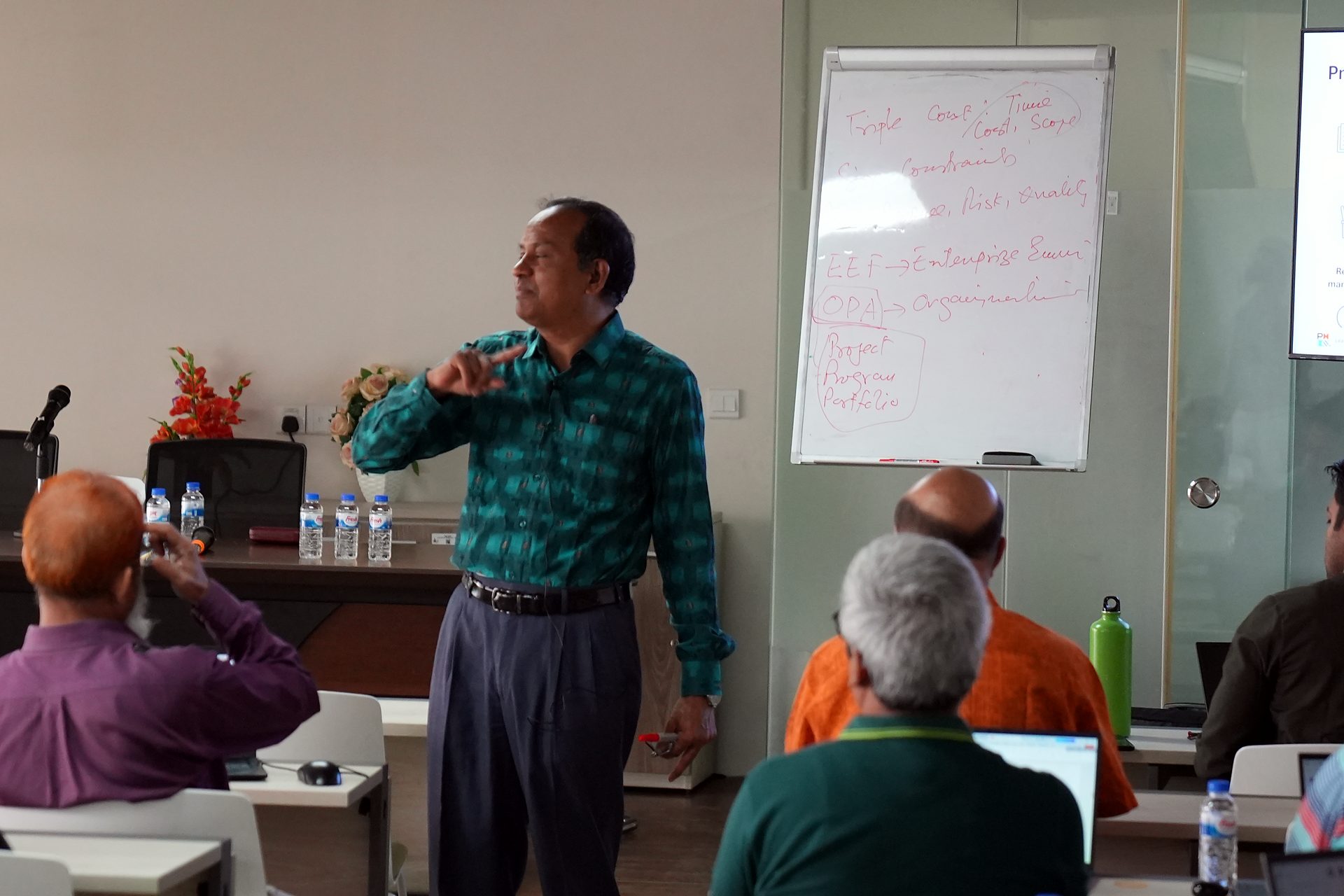 Trainer addressing the cohort beside a whiteboard