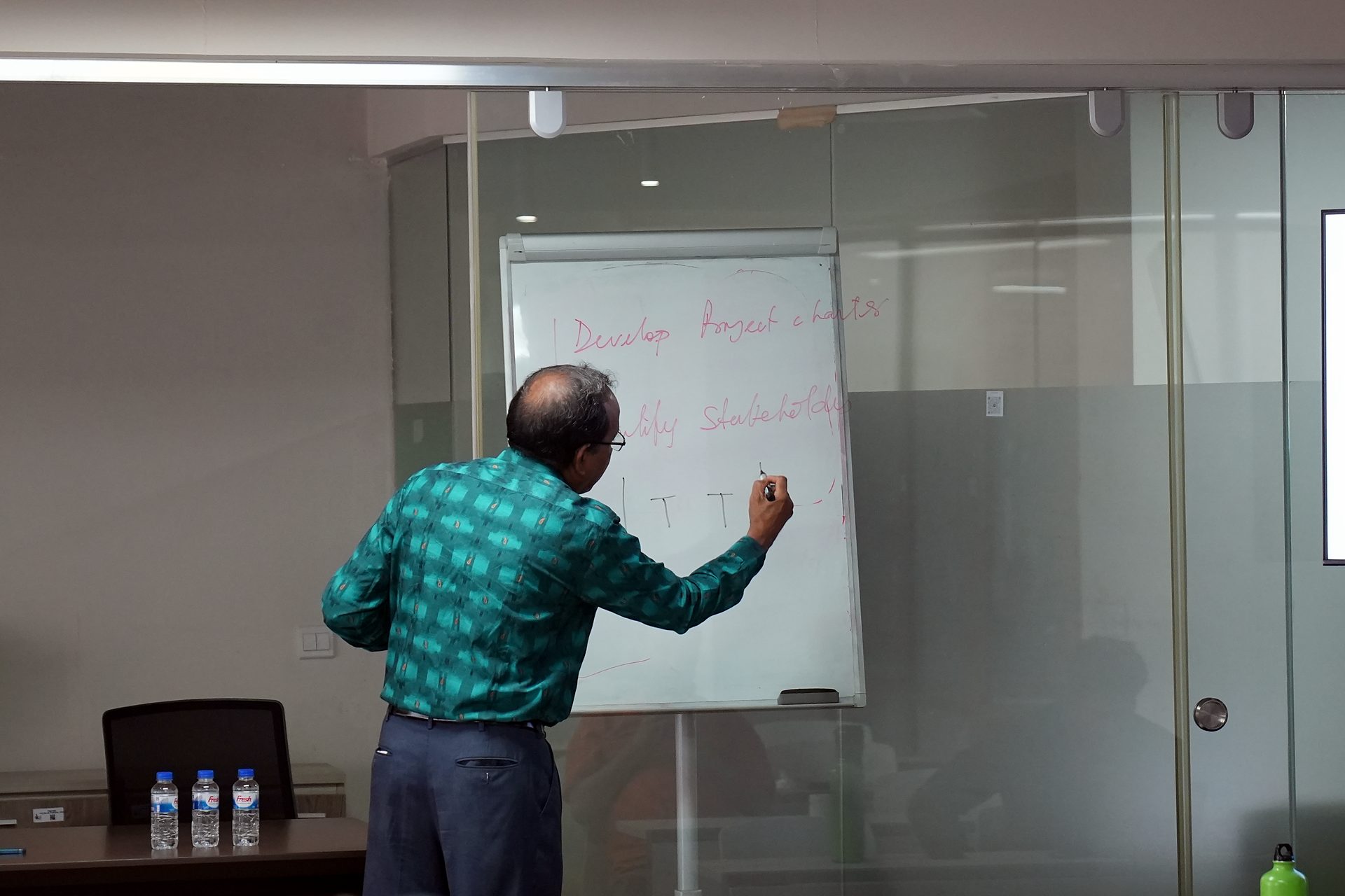 Trainer writing on the whiteboard