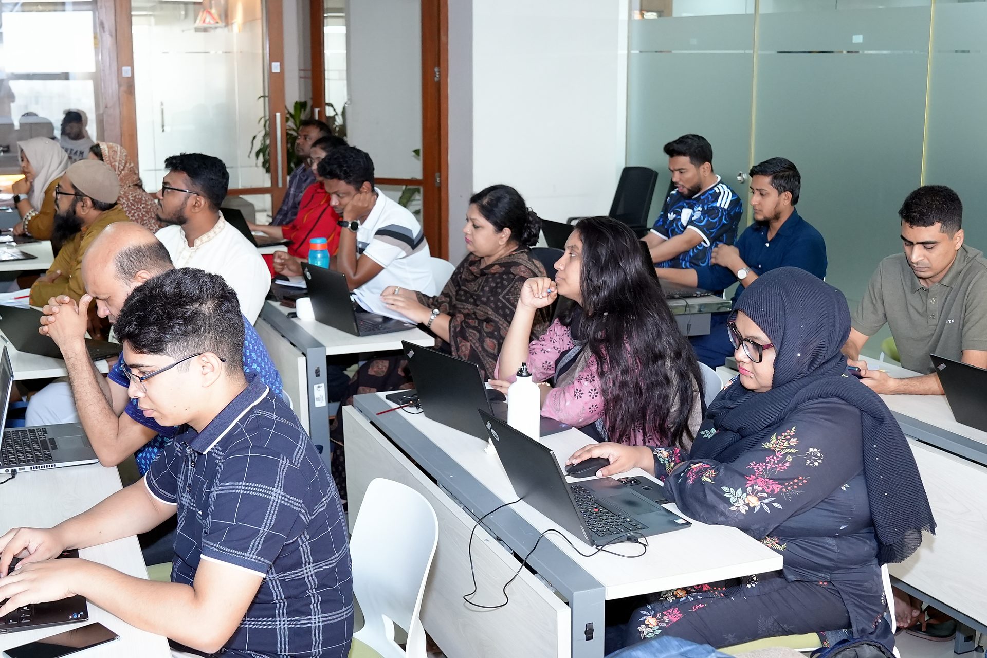 Participants following the session at their laptops