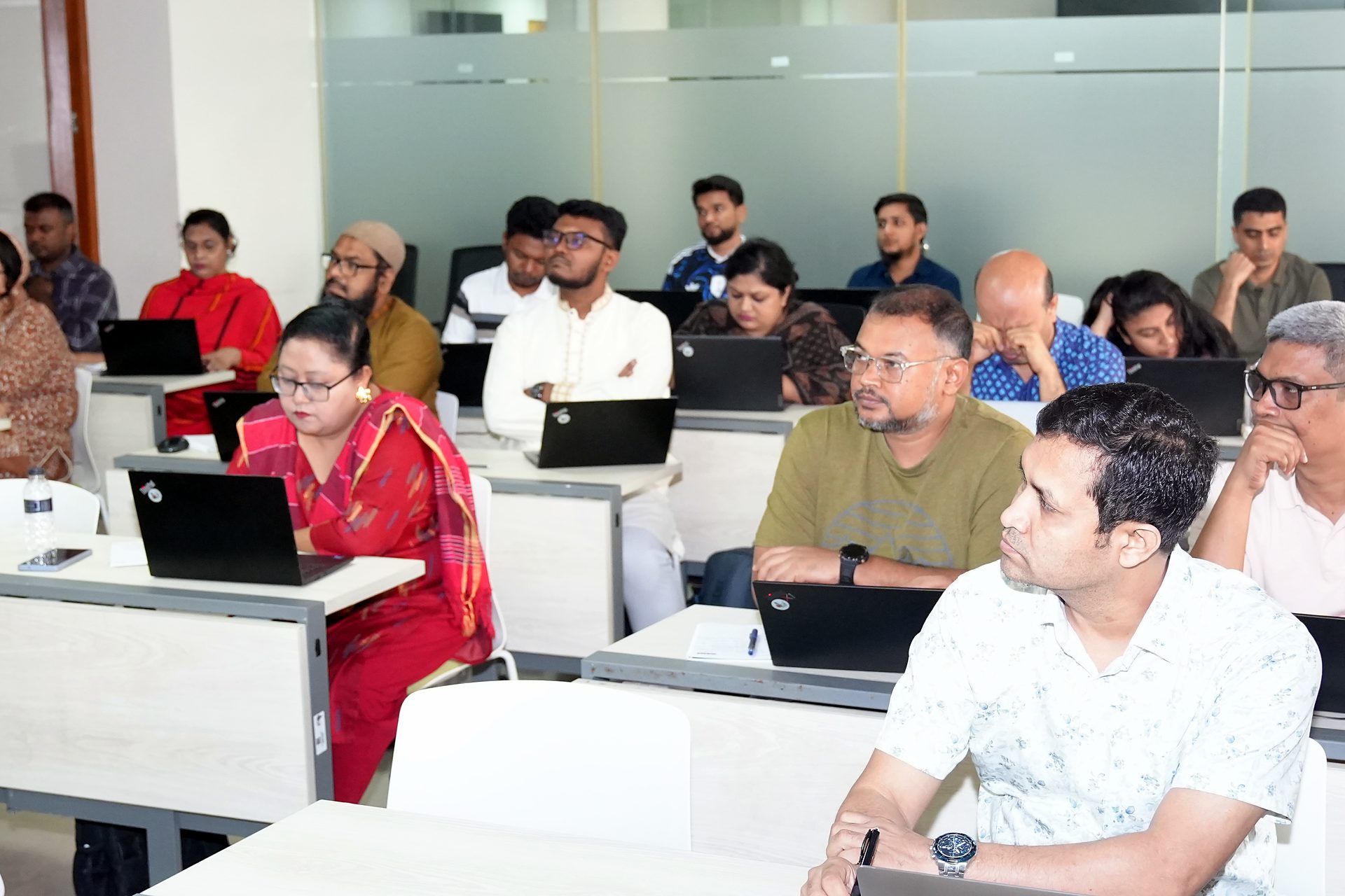 Participants at their laptops during Day 4