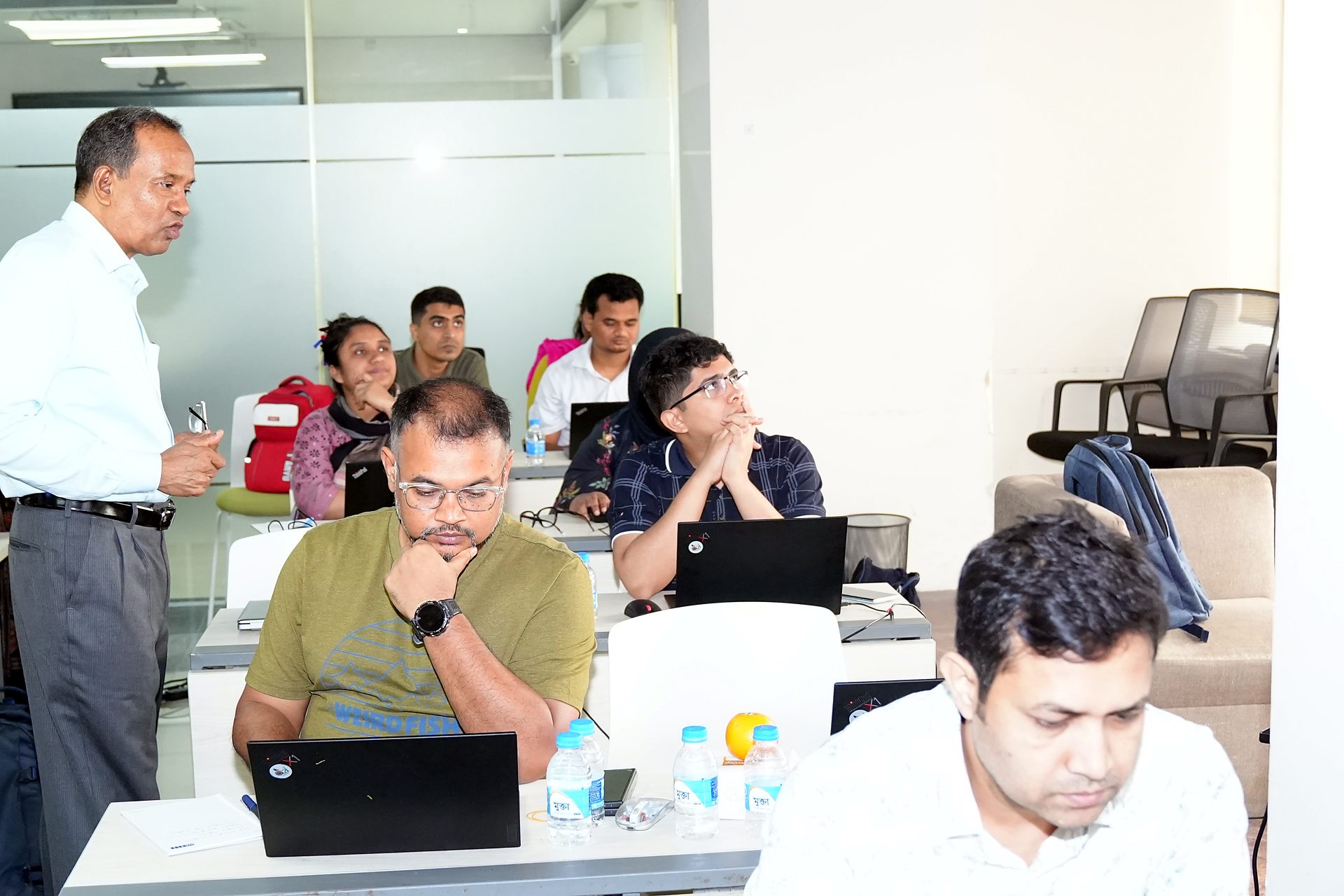 Trainer standing beside participants