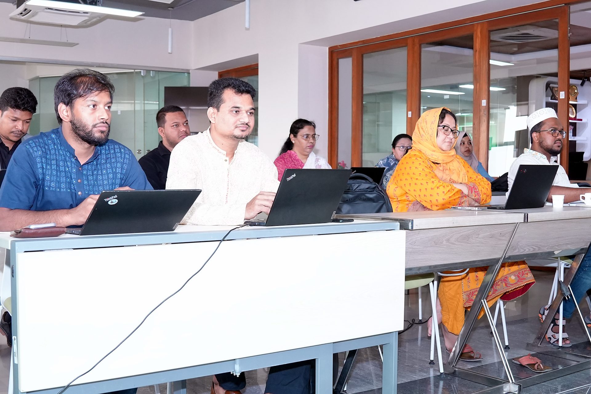 Participants in the second row of desks