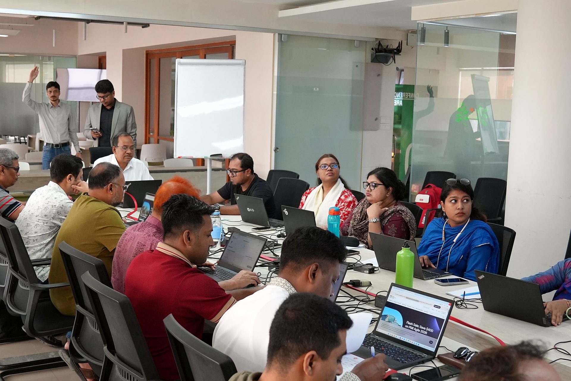Participants at boardroom tables in working groups