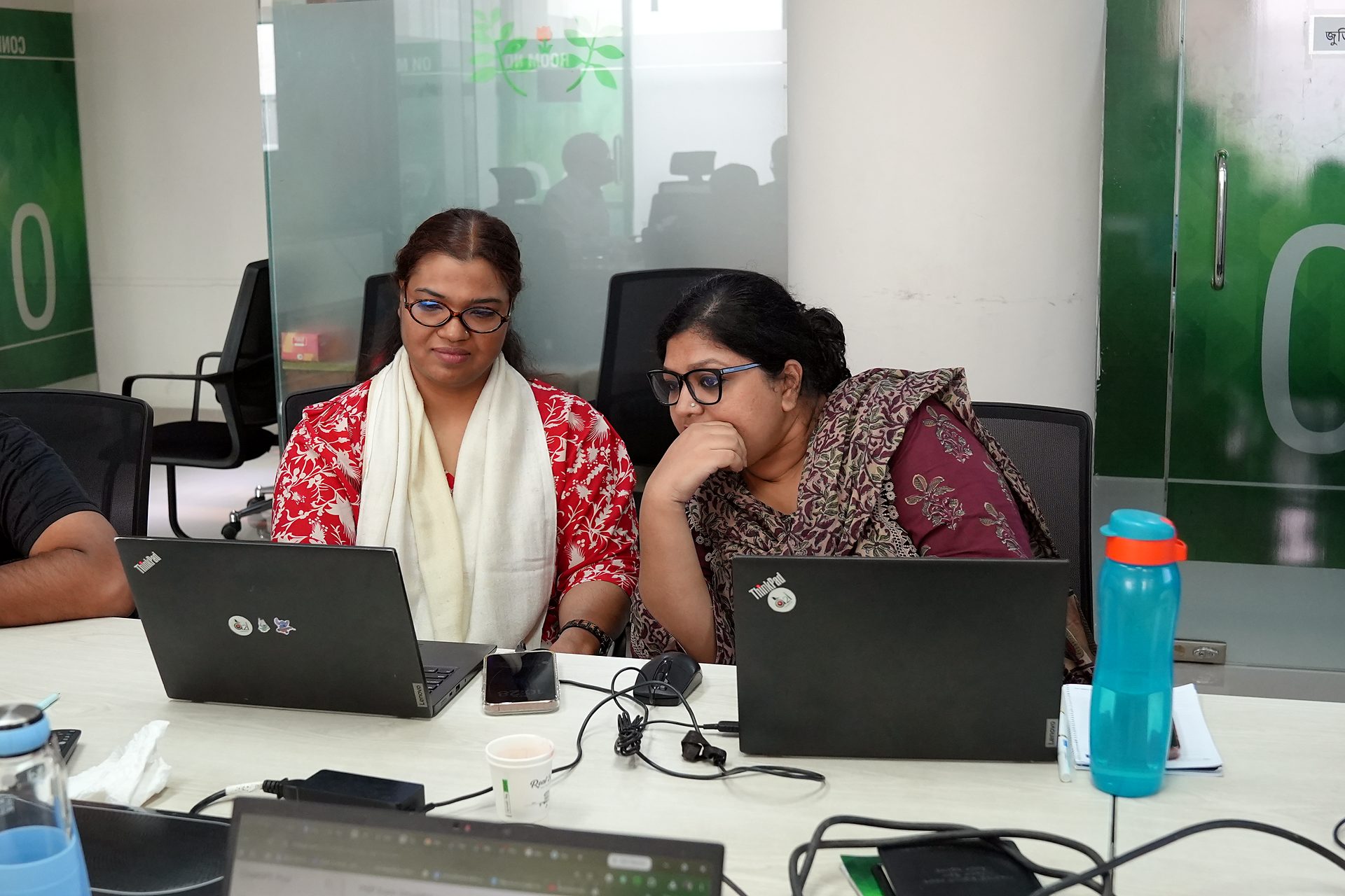 Participants working on laptops at the boardroom table