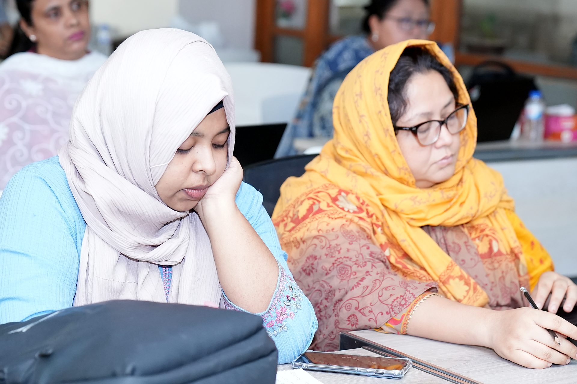 Two participants working at their laptops