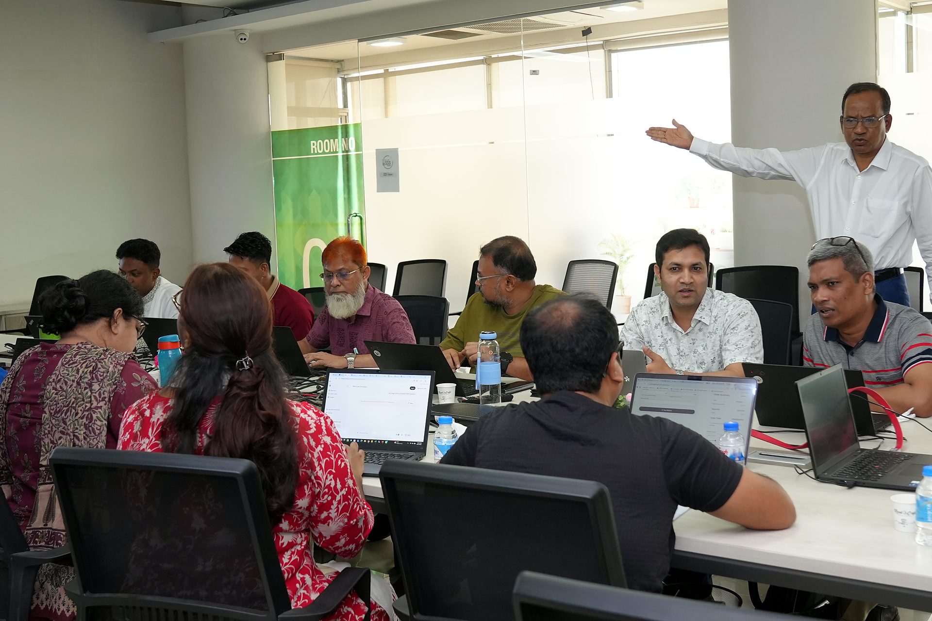 Trainer guiding a group at the boardroom table